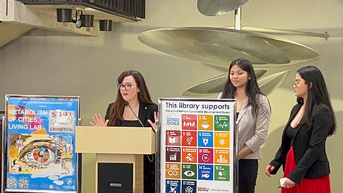 Gabriela Fernandez and two student artists speak at the opening of the UN Sustainable Development Goals exhibit in the Library