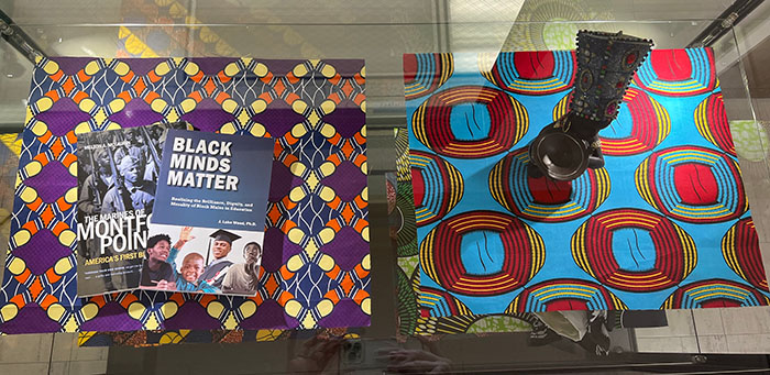 An Africana Studies Collection display case featuring books and artifacts.