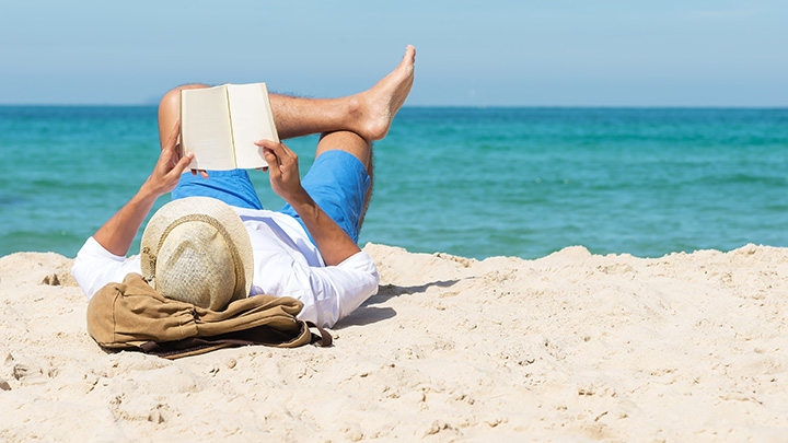 Person reading on the beach