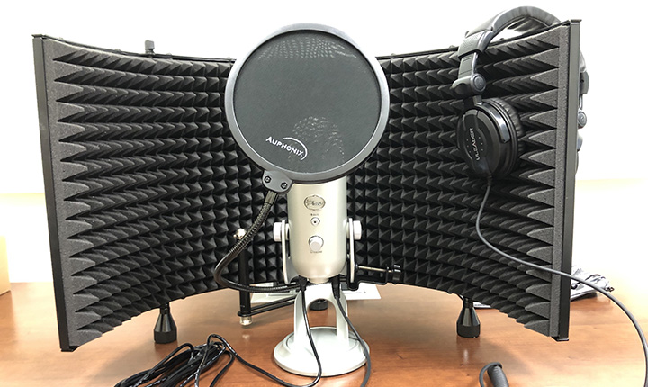 A basic podcasting setup - mic, headphones and sound barrier