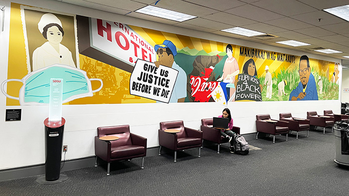 Colorful mural honoring Filipino American activism above lounge seating in the SDSU Library After Hours Study Area.